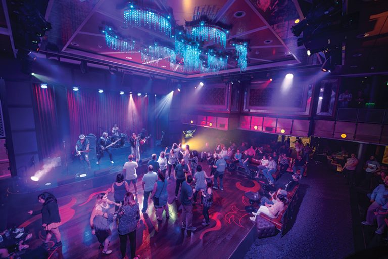 OV, Ovation of the Seas, Music Hall, nightlife, venue, entertainment, overhead shot of stage and dance floor, band on stage, musicians playing, guests dancing, fun, music, chandeliers above, spotlights