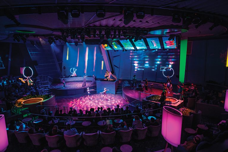 OV, Ovation of the Seas, Two70 show, roboscreens, Pixels, entertainment, night, wide shot of performers on stage, singing, singers, actors, dancers, musicians playing, audience in round, spotlights