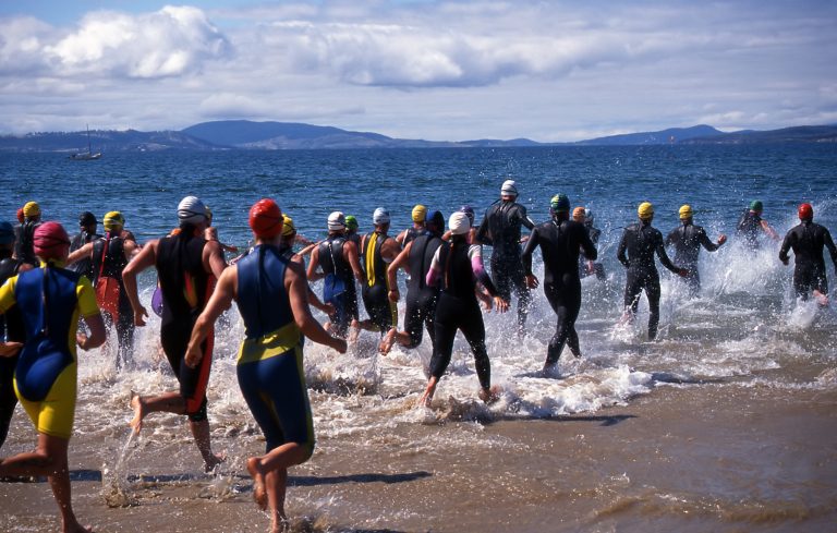 Competitors in Triathlon entering the water for the swimming leg