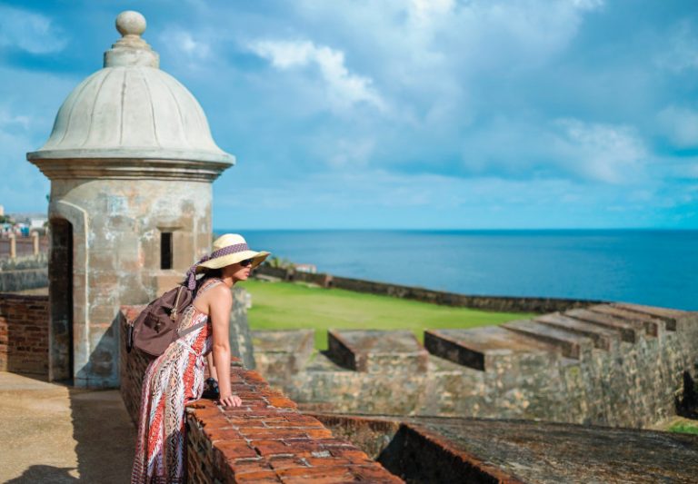 Instameet, Puerto Rico, Old San Juan, Moro Fort, history, Architecture, Woman wearing wide sun hat looking out to sea over the fort wall, scenery, ocean horizon,